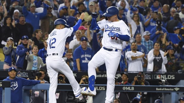 Oct 3, 2019; Los Angeles, CA, USA; Los Angeles Dodgers left fielder Joc Pederson (31) celebrates with third base coach Dino Ebel (12) after a solo home run during the eighth inning in game one of the 2019 NLDS playoff baseball series against the Washington Nationals at Dodger Stadium.